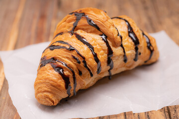 Delicious snack croissant on wood