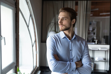 Fototapeta premium Close up confident businessman executive looking to aside out window, business vision concept, startup founder company owner boss visualizing future, new opportunities, thinking about future