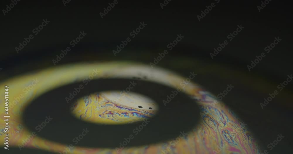 Poster light patterns emerging on a small soap bubble revealing abstract forms and shapes on the sphere. ma