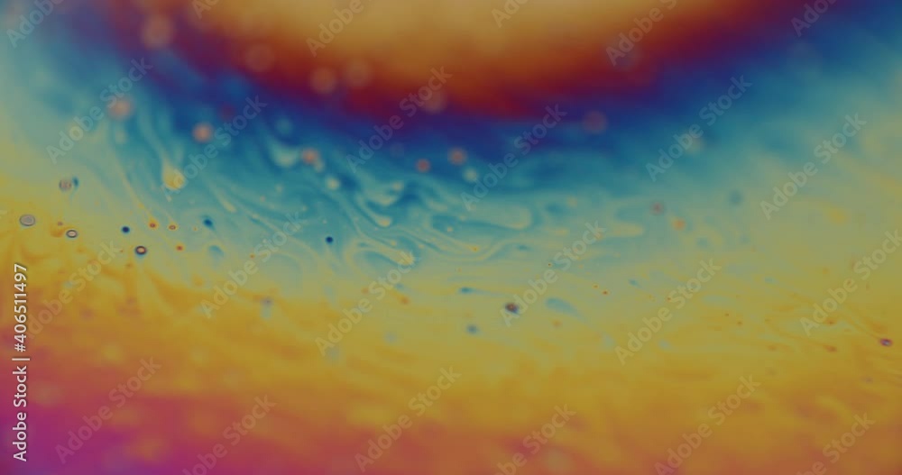 Poster fascinating shot of a multi colored liquid moving through the frame, color changing. small waves, dr
