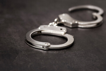 The metal handcuffs on black background. Handcuff or shackle. Police handcuffs