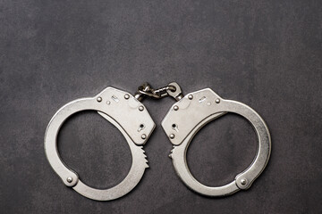 The metal handcuffs on black background. Handcuff or shackle. Police handcuffs