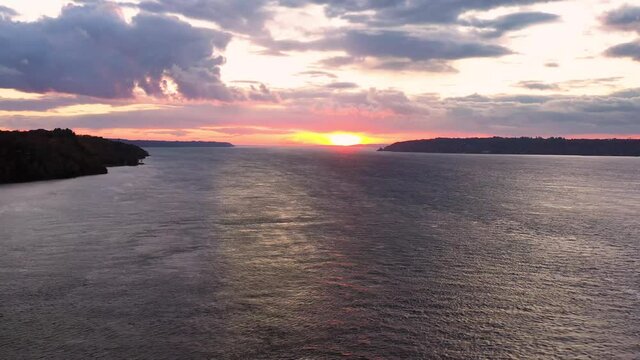 Stunning sunset going down the St-Laurent River. Pull back shot captured with the Mavic 2 Pro revealing the immensity of the river. Shot during the fall season in Quebec City, Canada