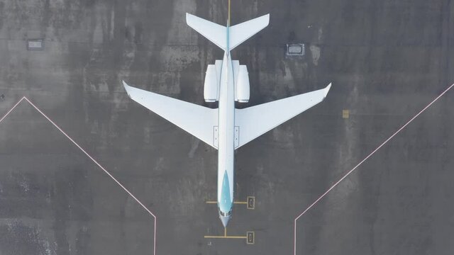Parked expensive private airplane on concrete ground of airport, aerial