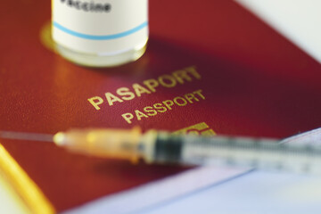 Close up shot of a coronavirus vaccine bottle with a Red colored Turkey's passport.