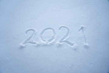 The numeral symbols of New Year 2021 are written in the snow.