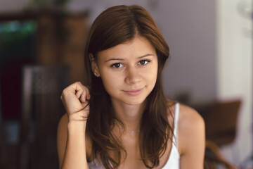 Young girl in cafe looking right to the camera