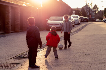 enfant jouent au foot dans la rue