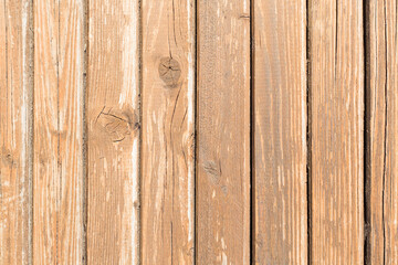 Thin wood planks in vertical position. Light wood worn out by sun and time.