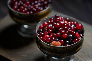 close-up of delicious and healthy breakfast. selective focus photo of chia seeds, natural yogurt, and fresh berries such as cranberries, strawberries and currants. healthy food concept.