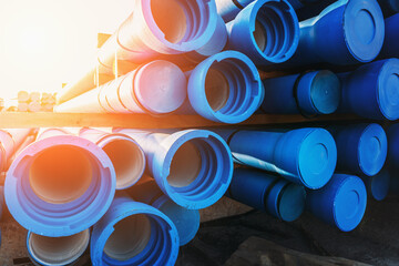 Pack of blue sewer pipe, ready to transport and install. - obrazy, fototapety, plakaty