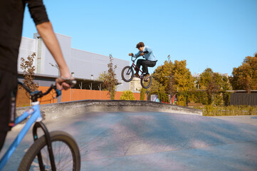 Bmx rider, jump in action, training in skatepark