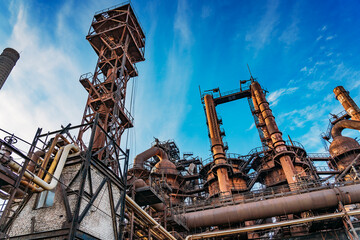 Fototapeta na wymiar Metallurgical plant or factory blast furnace and smokestacks. Industrial iron background.