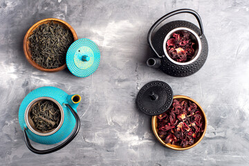 various teas prepared for brewing in different teapots