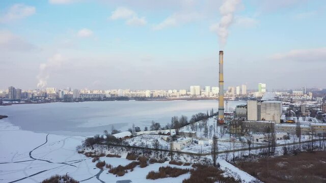 Waste incinerator plant with smoking smokestack at the winter. The problem of environmental pollution by factories aerial view