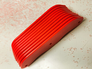 Red Fabricated PET-G With Debris Around It