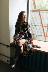 Naklejka premium Young elegant girl posing indoor. Pretty beautiful business woman in elegant dress