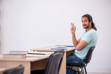 Young male student in the classroom during pandemic