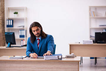 Young male employee working at workplace