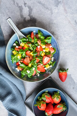 Healthy lettuce salad with mango, strawberry, pecan nuts and Feta cheese
