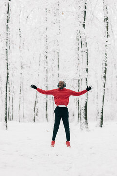 Young african american man doing exercise on winter day in forest