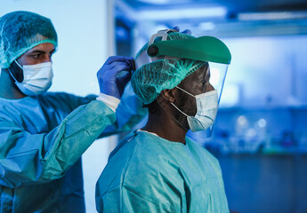 Doctors preparing and getting dressed to work inside hospital during coronavirus pandemic outbreak