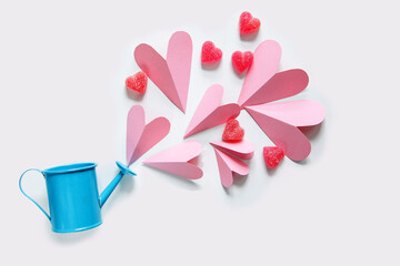 Floating pink hearts flying out of the watering can.