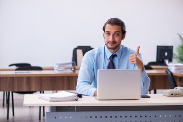 Young male employee working in the office