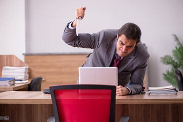 Young businessman employee in bullying concept in the office