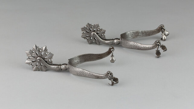 Pair of vintage rowel spurs on a white background