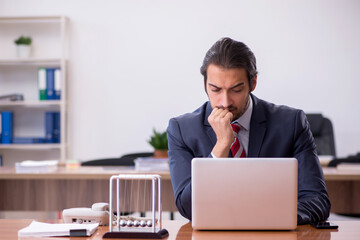 Young man businessman employee sitting in the office