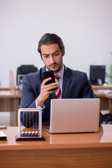 Young man businessman employee sitting in the office