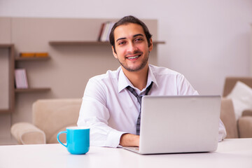 Young male employee working from home during pandemic