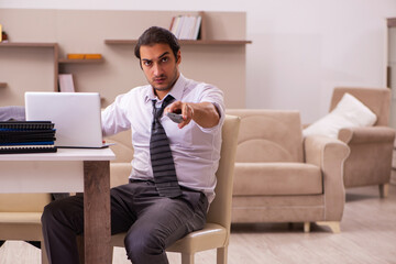 Young male employee working from home during pandemic