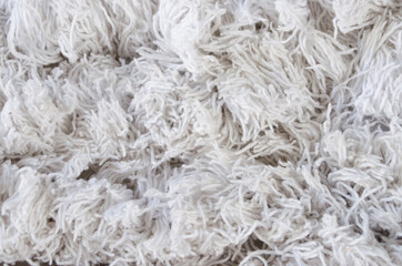 Closeup of white cotton shaggy carpet.