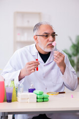 Old male chemist testing soap in the lab