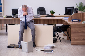 Old businessman employee in bankruptcy concept in the office