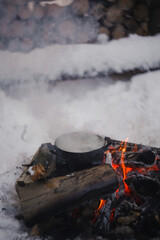 A pot on a fire in winter.