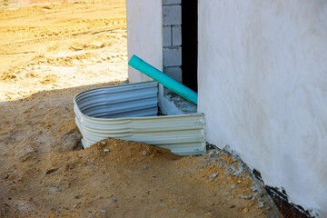 Building installation window well for basement construction on a new home