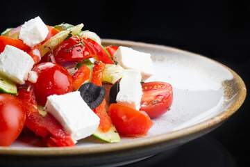 Greek salad with all cherry tomatoes, cucumber and lettuce and feta cheese, seasoned with olive oil