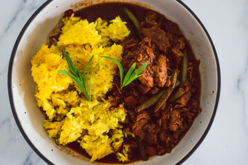 plant-based food, vegan turmeric rice and green beans stew with mock meat