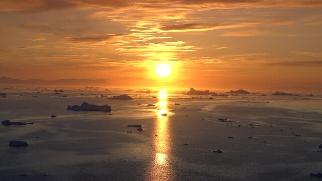 sunset time one arctic icebergs in greenland