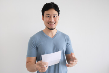 Happy Asian man is holding an invoice letter on isolated white background.