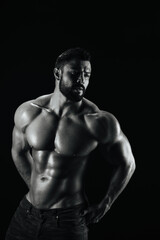 Fototapeta na wymiar Fitness male model standing on black background