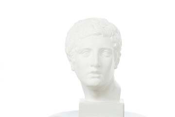 Brightly lit white marble head of young man over white background. On a square pedestal.
