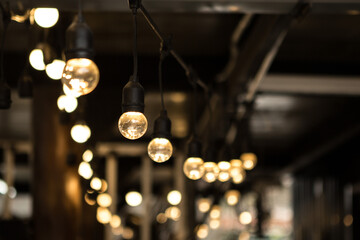 Selective focus of Decorative bulbs in cafes  on background blurred