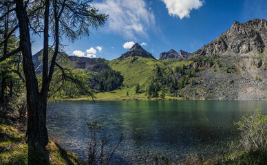 Fototapeta na wymiar Wild mountain lake on a summer day