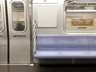 Subway seats and blank billboard