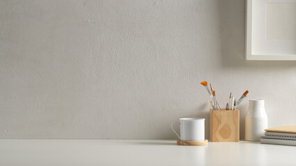 Workspace in home office room with copy space, supplies, cup and decorations