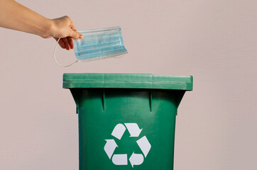 Throwing surgical mask into the recycle bin, medical waste